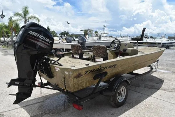 Slide: The Image of 2024 Tracker Grizzly 1754 SC boat with Mercury outboard motor on trailer. - 16