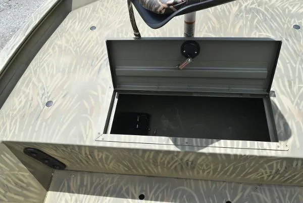 Slide: The Image of 2024 Tracker Grizzly 1754 SC boat storage compartment with open lid. - 21