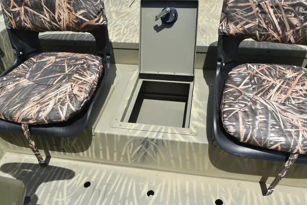 Slide: The Image of 2024 Tracker Grizzly 1754 SC boat interior with camo seats and storage compartment. - 25
