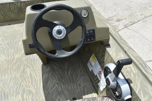 Slide: The Image of 2024 Tracker Grizzly 1754 SC boat steering console and throttle control. - 26