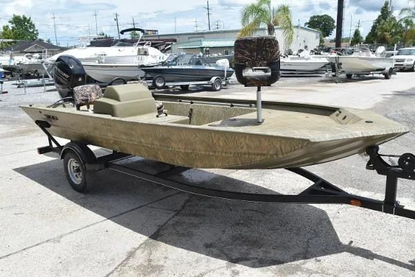 Slide: The Image of 2024 Tracker Grizzly 1754 SC fishing boat on trailer in marina. - 4