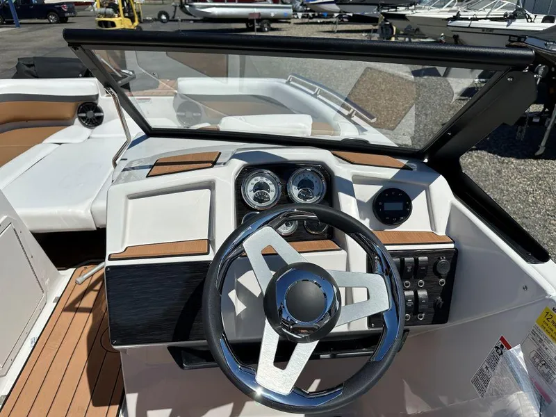 Slide: The Image of 2024 Starcraft SVX 190 OB DC boat dashboard with steering wheel and gauges. - 5