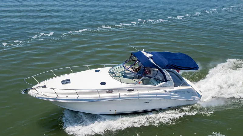 Slide: The Image of 2005 Sea Ray 340 Sundancer cruising on open water. - 11