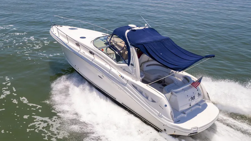 Slide: The Image of 2005 Sea Ray 340 Sundancer cruising on open water. - 13