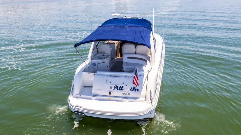 Slide: The Image of 2005 Sea Ray 340 Sundancer boat with blue canopy on water. - 19