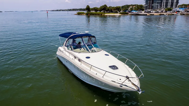 Slide: The Image of 2005 Sea Ray 340 Sundancer cruising on calm waters near a coastal area. - 26