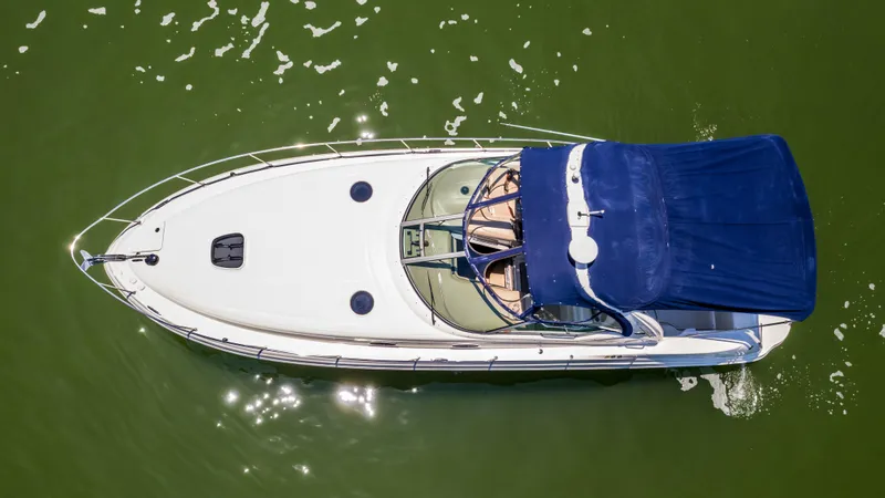 Slide: The Image of Aerial view of a 2005 Sea Ray 340 Sundancer boat on green water. - 27