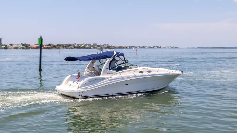 Slide: The Image of 2005 Sea Ray 340 Sundancer cruising on a calm waterway. - 3