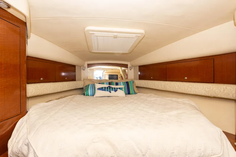 Slide: The Image of 2005 Sea Ray 340 Sundancer cabin with cozy bed and storage cabinets - 35