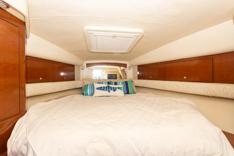 Slide: The Image of Interior cabin of 2005 Sea Ray 340 Sundancer with bed and storage cabinets. - 36