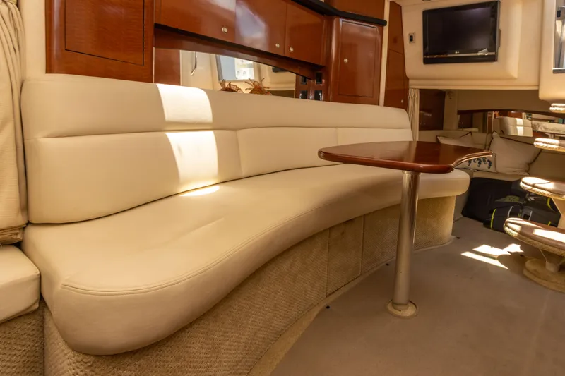 Slide: The Image of Interior of 2005 Sea Ray 340 Sundancer with cream leather seating and wooden table. - 39