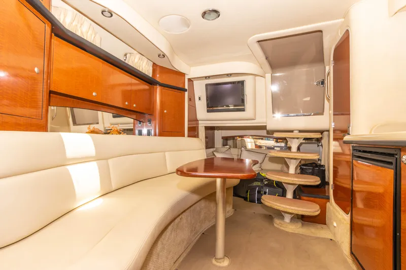 Slide: The Image of Interior of 2005 Sea Ray 340 Sundancer yacht with seating, table, and TV. - 40