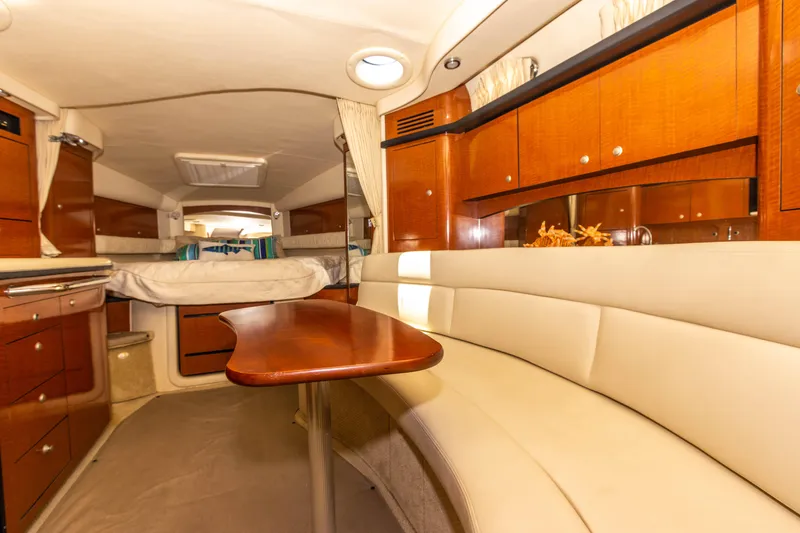 Slide: The Image of Interior of 2005 Sea Ray 340 Sundancer yacht with wooden cabinetry and white seating. - 42