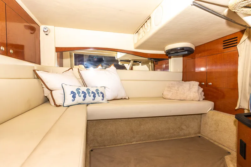 Slide: The Image of Interior cabin of a 2005 Sea Ray 340 Sundancer yacht with beige seating and decorative pillows. - 44