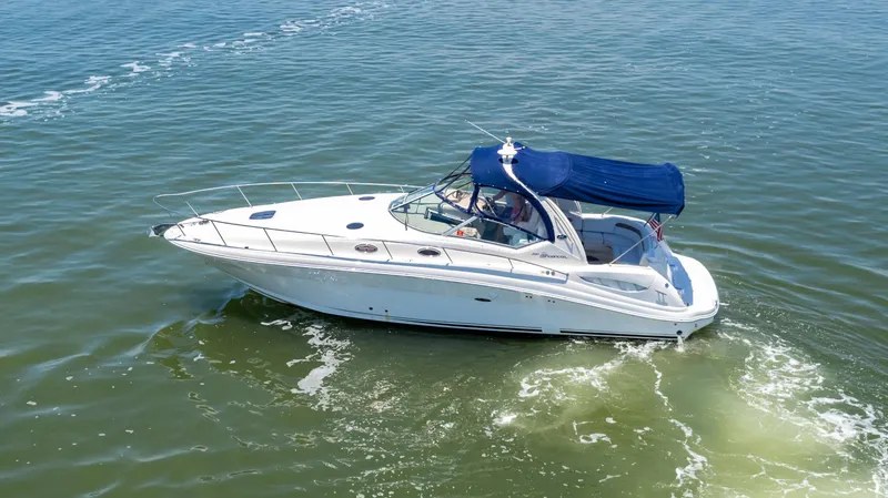 Slide: The Image of 2005 Sea Ray 340 Sundancer cruising on open water. - 8