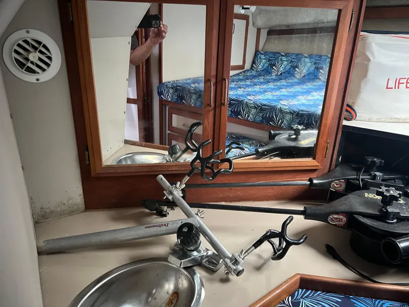 Slide: The Image of 1987 Carver Voyager cabin interior with fishing rod holders and nautical decor. - 23