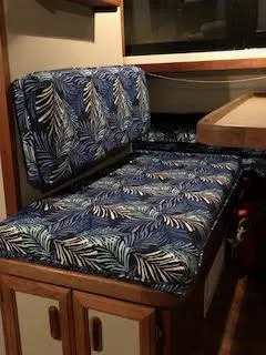 Slide: The Image of 1987 Carver Voyager interior with tropical-patterned seating and wooden cabinetry. - 11