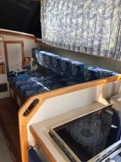 Slide: The Image of 1987 Carver Voyager interior with blue patterned seating and wooden accents. - 15