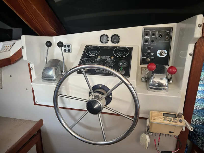 Slide: The Image of Control panel of a 1987 Carver Voyager boat with steering wheel and gauges. - 20