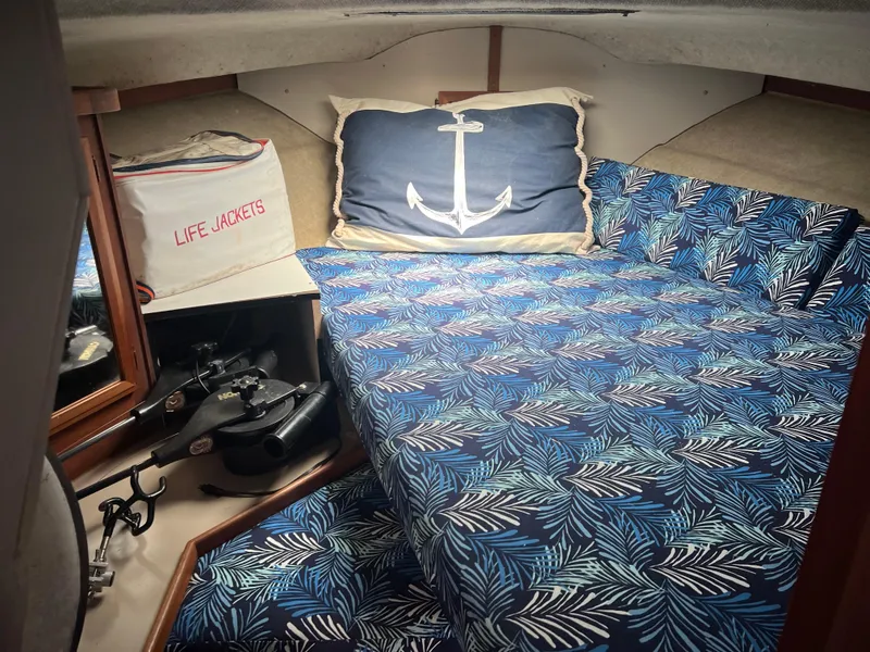 Slide: The Image of Cozy cabin interior of 1987 Carver Voyager with nautical-themed bedding and life jackets. - 21