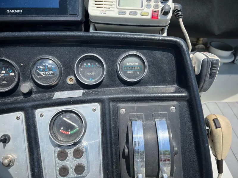 Slide: The Image of Control panel of a 1987 Carver Voyager boat with gauges and throttle levers. - 28