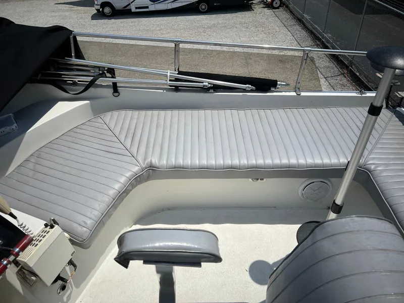 Slide: The Image of 1987 Carver Voyager boat interior with gray seating and steering wheel. - 30
