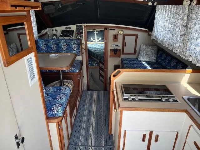 Slide: The Image of Interior of a 1987 Carver Voyager boat with kitchen and seating area. - 9