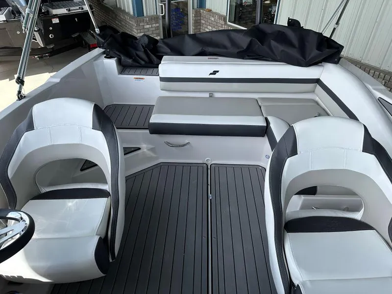 Slide: The Image of 2024 Starcraft SVX 210 OB DC boat interior with white and black seating. - 6