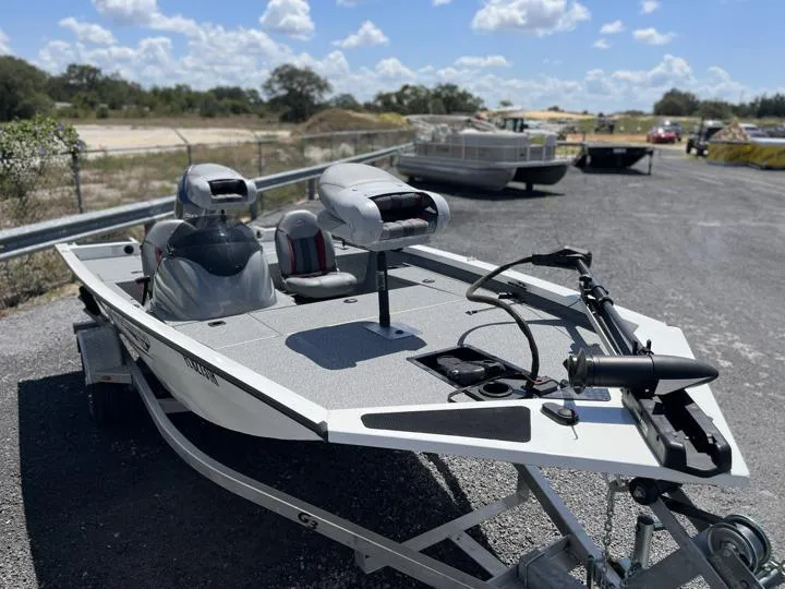 Slide: The Image of 2022 G3 Sportsman 1610 fishing boat on trailer, equipped with trolling motor and outboard engine. - 8