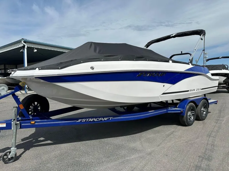 The Image of 2024 Starcraft SVX 211 OB boat on trailer, covered and ready for transport. - 0