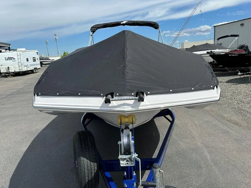 Slide: The Image of 2024 Starcraft SVX 211 OB boat with black cover on trailer. - 2