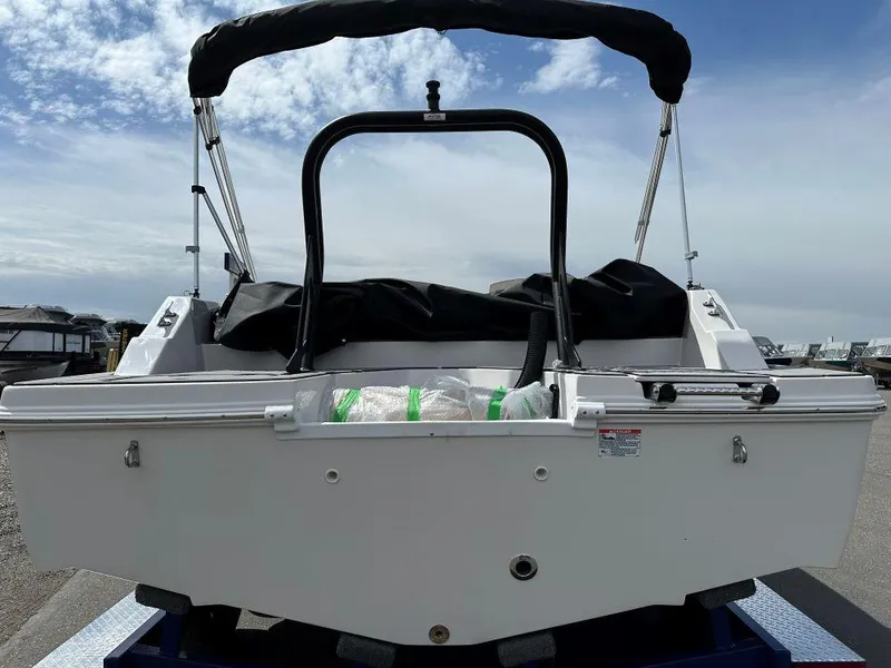 Slide: The Image of 2024 Starcraft SVX 211 OB boat rear view with bimini top. - 3