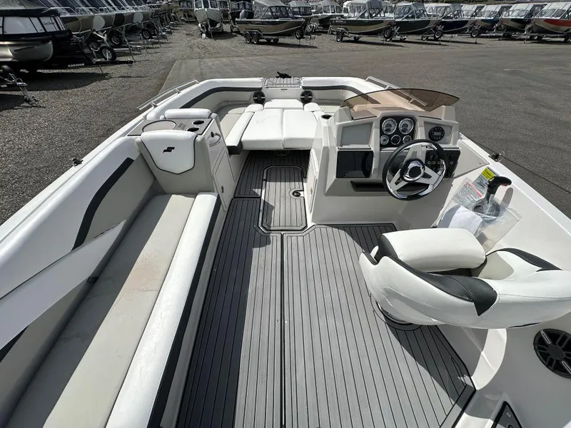 Slide: The Image of 2024 Starcraft SVX 211 OB boat interior with seating and steering console. - 6