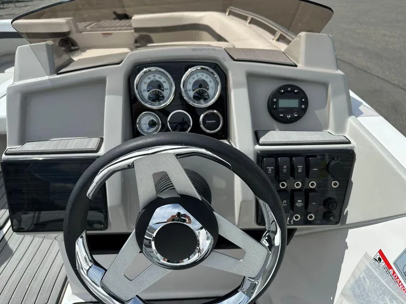 Slide: The Image of 2024 Starcraft SVX 211 OB boat dashboard with steering wheel and control panel. - 7