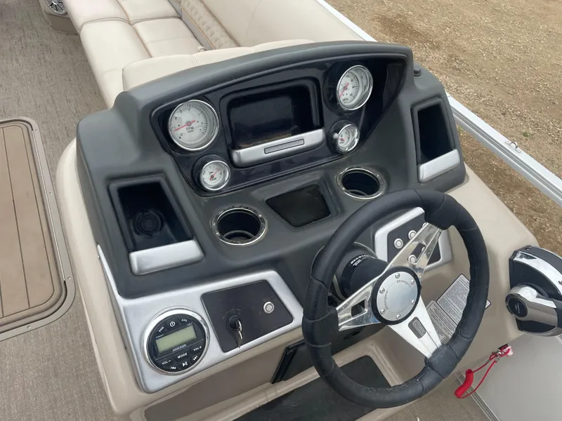 Slide: The Image of 2023 Ranger Reata 223C boat dashboard with steering wheel, gauges, and controls. - 13