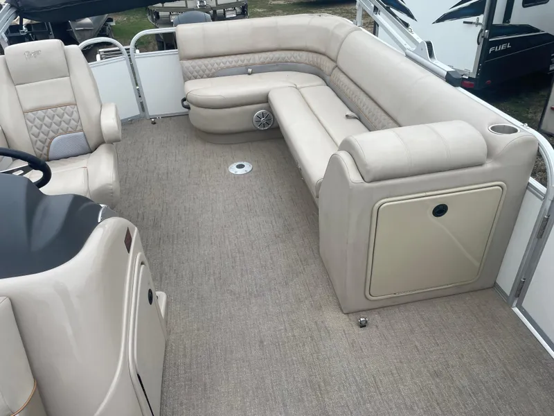 Slide: The Image of 2023 Ranger Reata 223C pontoon boat interior with beige seating and carpet. - 4