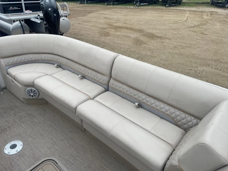 Slide: The Image of 2023 Ranger Reata 223C boat with beige cushioned seating. - 7