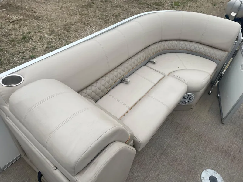 Slide: The Image of 2023 Ranger Reata 223C boat with beige cushioned seating. - 8