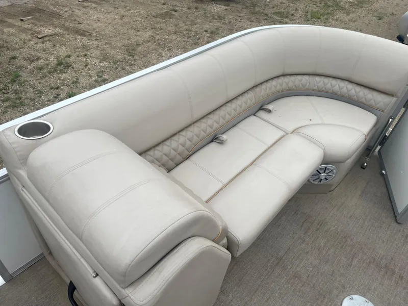 Slide: The Image of 2023 Ranger Reata 223C boat with beige leather seating and cup holder. - 9