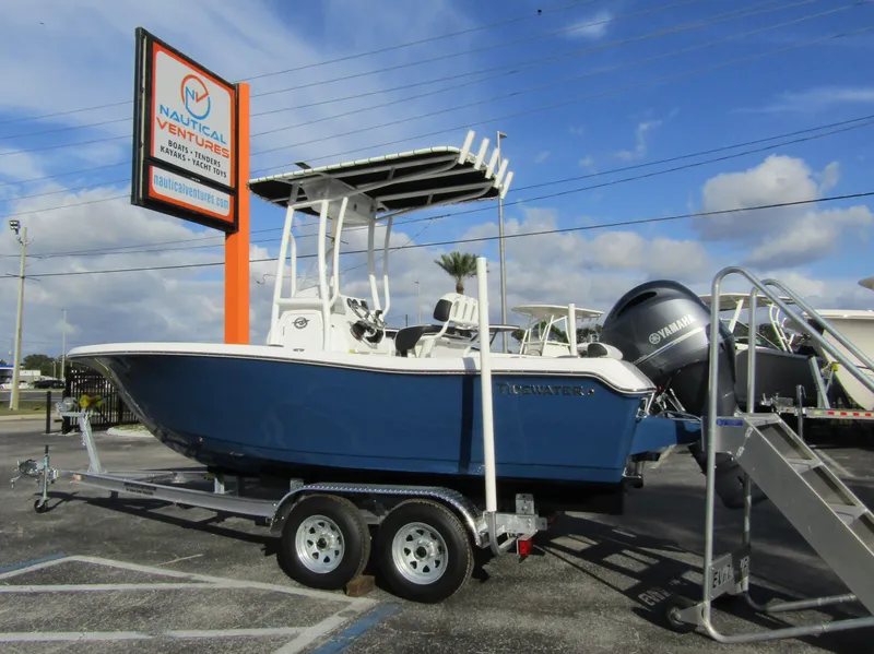 Slide: The Image of 2023 Tidewater 198 CC Adventure boat on trailer at Nautical Ventures dealership. - 1