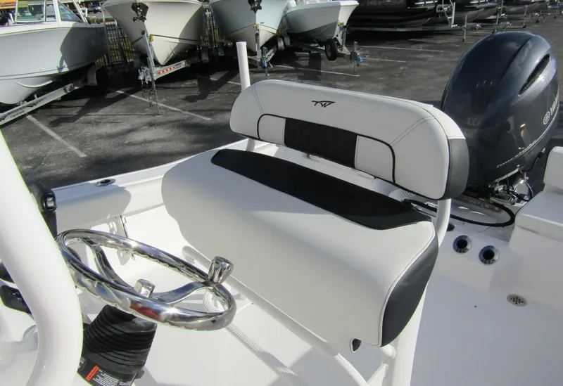 Slide: The Image of 2023 Tidewater 198 CC Adventure boat interior with steering wheel and seating. - 15