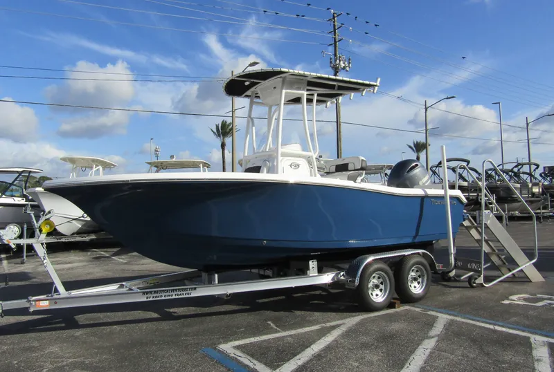 Slide: The Image of 2023 Tidewater 198 CC Adventure boat on a trailer in a parking lot. - 6