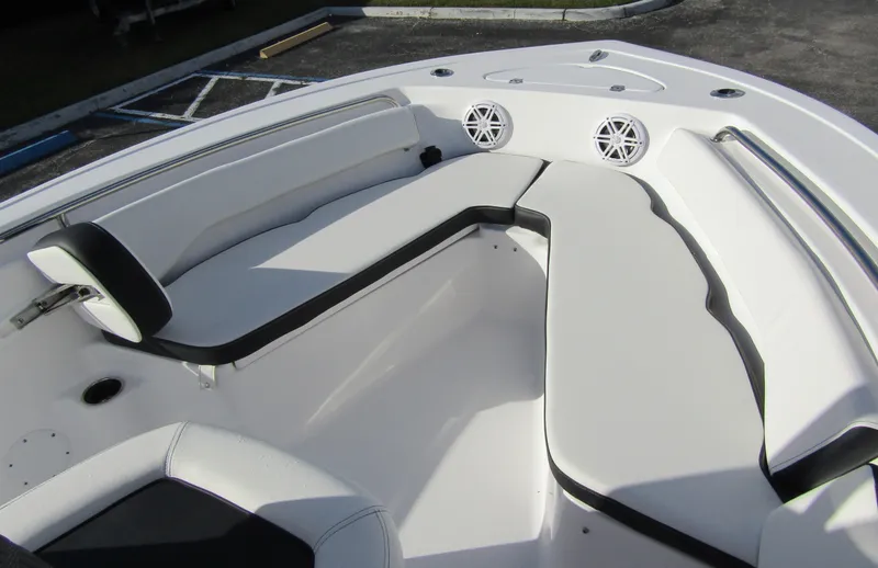 Slide: The Image of 2023 Tidewater 198 CC Adventure boat interior with cushioned seating and built-in speakers. - 11