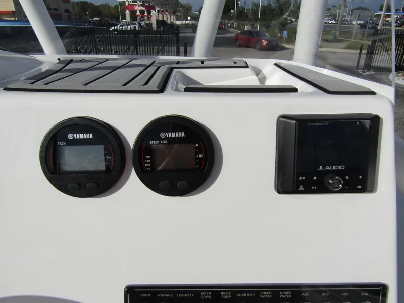 Slide: The Image of 2023 Tidewater 198 CC Adventure dashboard with Yamaha gauges and JL Audio system. - 18