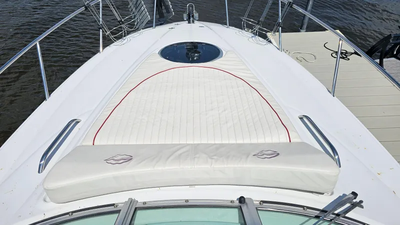 Slide: The Image of 2010 Crownline 260 CR boat with white cushioned deck and stainless steel railings. - 13