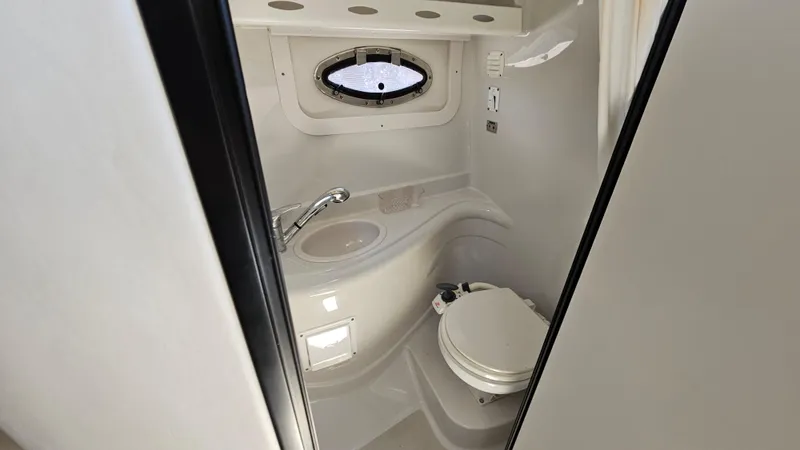 Slide: The Image of 2010 Crownline 260 CR boat bathroom with sink and toilet. - 20