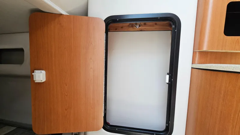 Slide: The Image of Open storage compartment in 2010 Crownline 260 CR boat interior. - 22