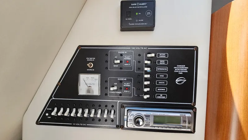 Slide: The Image of Crownline 260 CR 2010 control panel with switches and stereo system. - 23