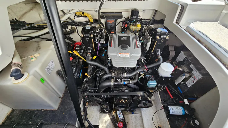 Slide: The Image of Engine compartment of a 2010 Crownline 260 CR boat, showcasing the engine and components. - 24