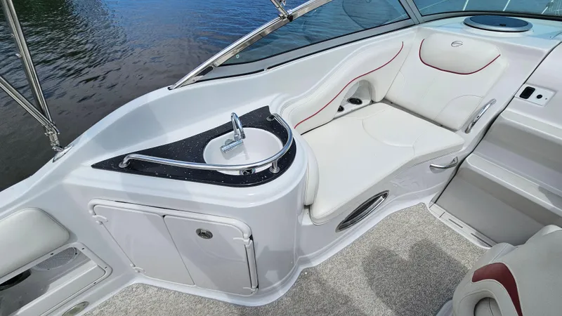 Slide: The Image of 2010 Crownline 260 CR boat interior with sink and seating area. - 8